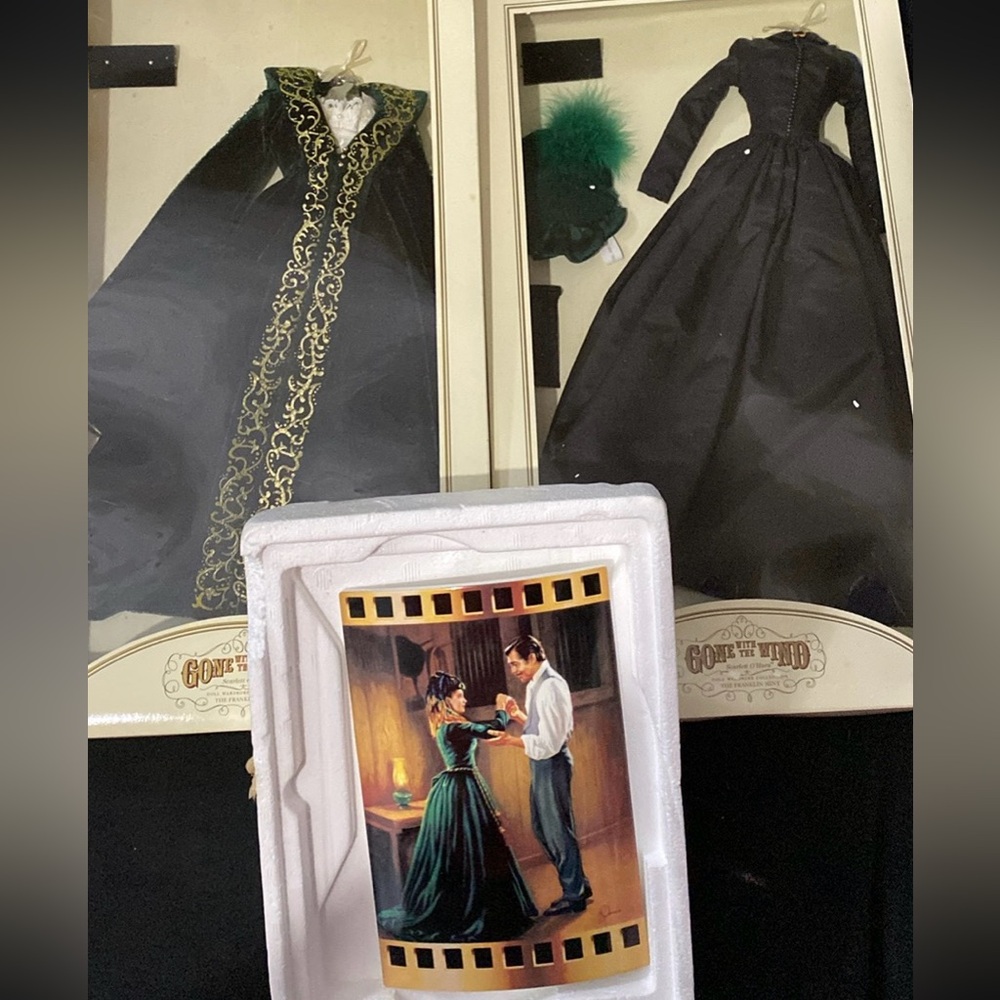 Two doll dresses was from gone with thee with the wind still in boxes & a plaque